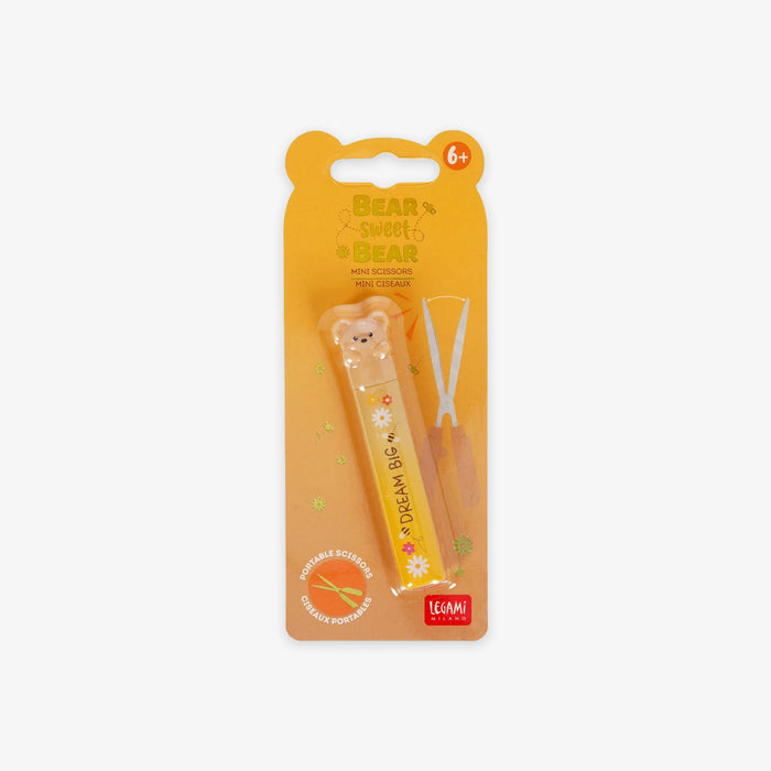 Packaged children's scissors with a bear design on an orange background