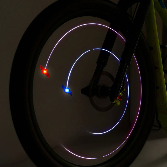 Bicycle with a blue and red light shining in the wheel at night.
