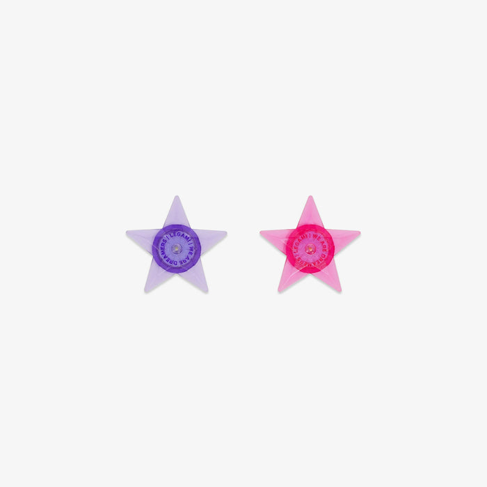 Two star-shaped lights for bike, one purple and one pink, on a white background