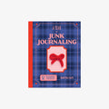Book titled 'A Year of Junk Journaling' with a red bow design on a blue plaid background