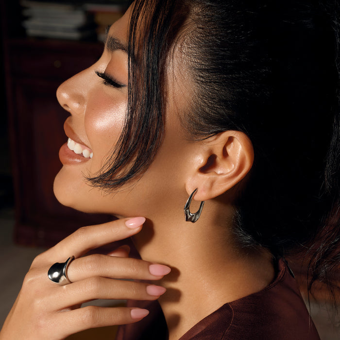 Silver stainless steel sculptural hoop earrings with modern organic shape, hypoallergenic earrings for sensitive ears, non-tarnish durable contemporary statement jewelry Canada.