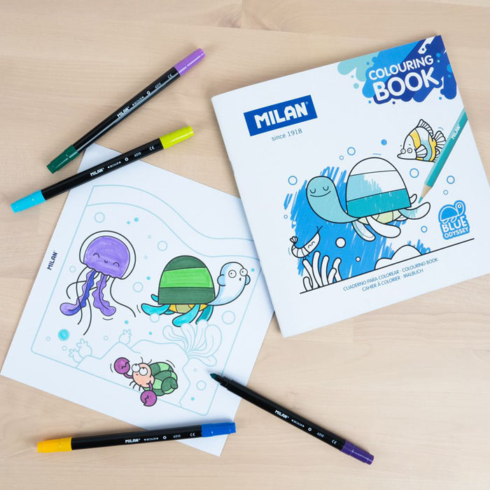 Milan colouring book with underwater-themed pages and coloured pencils on a wooden surface