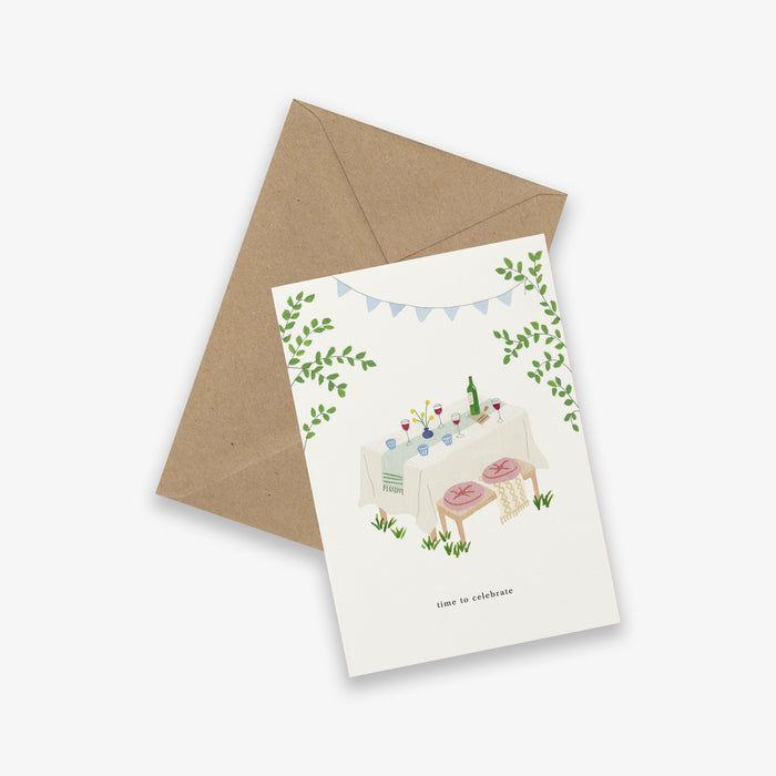 Greeting card with illustration of a party scene and envelope on a white background. with the text 'time to celebrate'