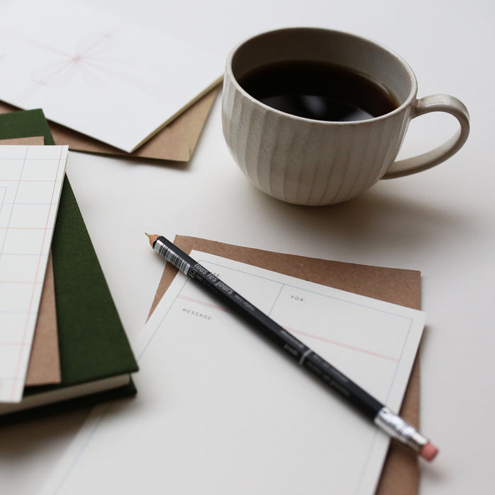 Greeting card with simple illustration with pen and coffee.