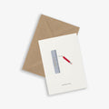 A greeting card with an illustration of a ruler and a pencil and with the text 'getting so big', accompanied by a brown kraft envelope, on a white background.