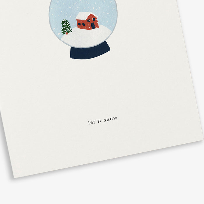 A greeting card with a snowglobe illustration and the text 'let it snow'.