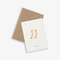 A greeting card with an illustration of socks and the text 'quite the pair', accompanied by a brown kraft envelope.