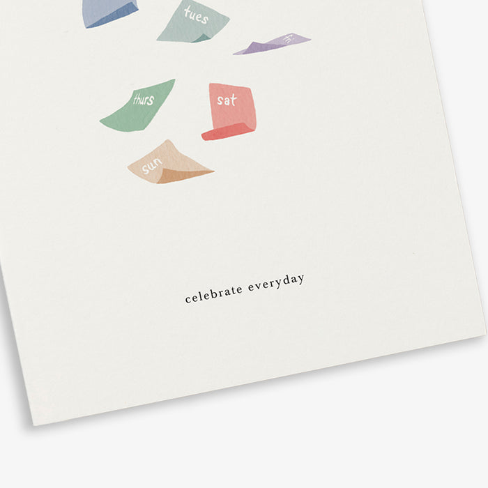 A greeting card with illustration of colorfull calendar sheets falling and the text 'celebrate everyday'.