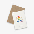 A greeting card with a colorful xylophone illustration and the text 'a tune for you' accompanied by a brown kraft envelope.