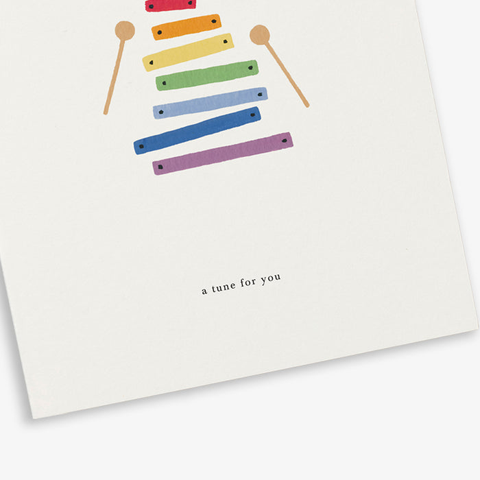 A greeting card with a colorful xylophone illustration and the text 'a tune for you'.