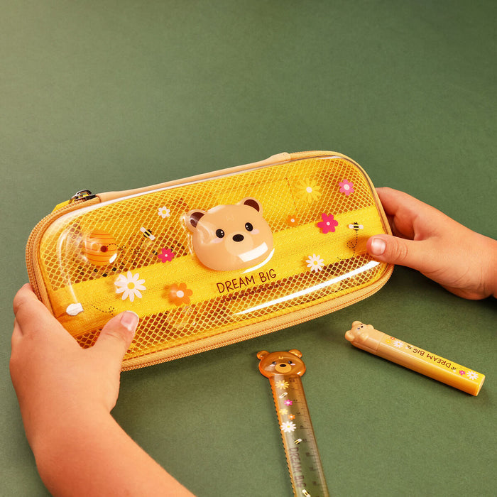Hardcase pencil case with bear design held by a hand on a green background