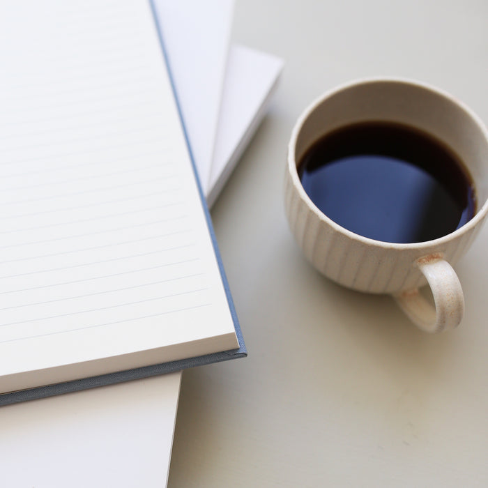 Table setup with a light blue hardcover notebook.
