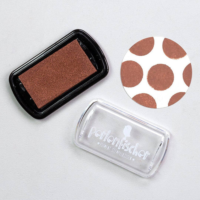 Brown ink pad with a stamp and a polka dot design on a white background