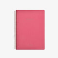 Pink notebook with spiral binding on a white background