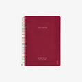 Red notebook with spiral binding on a white background