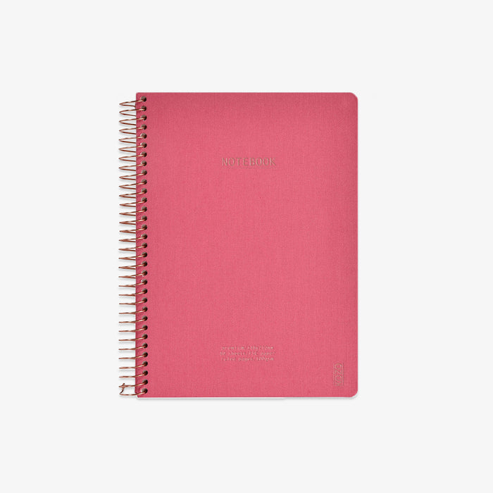 Pink notebook with spiral binding on a white background