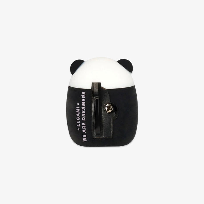 Panda-shaped pencil sharpener with black and white design on a light gray background