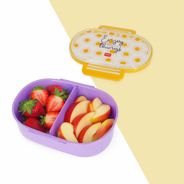A two-compartment lunch box in light purple with a matching lid, shown with sliced strawberries and peach slices inside. The lid has yellow polka dots and the text 'Enjoy things!' with a small red Yupoong logo.