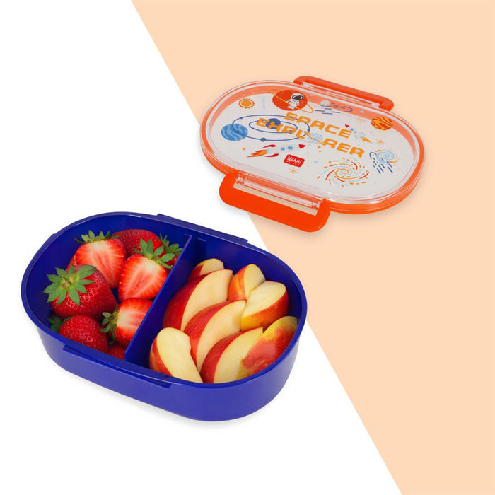 Snack box with compartments filled with strawberries and apple slices, on a beige background