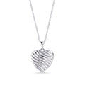 Silver stainless steel ribbed heart pendant necklace close-up, sculptural romantic jewelry design, hypoallergenic non-tarnish durable statement necklace, modern elegant heart jewelry.