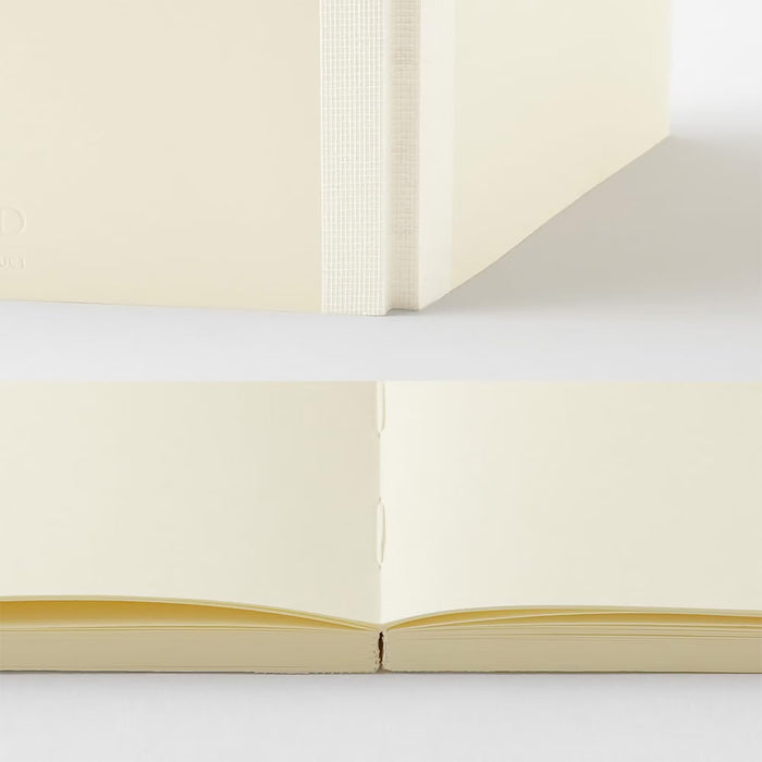 Open notebook with cream-colored pages on a light gray background