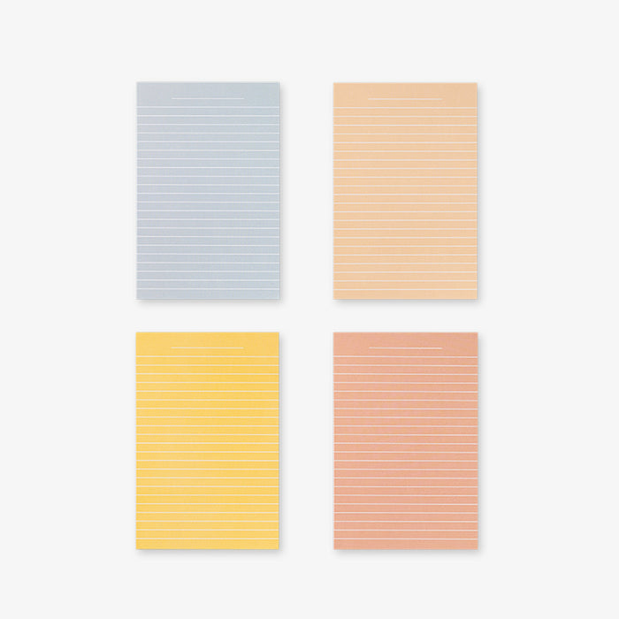 Four Memo Cards with different pastel colors on a white background