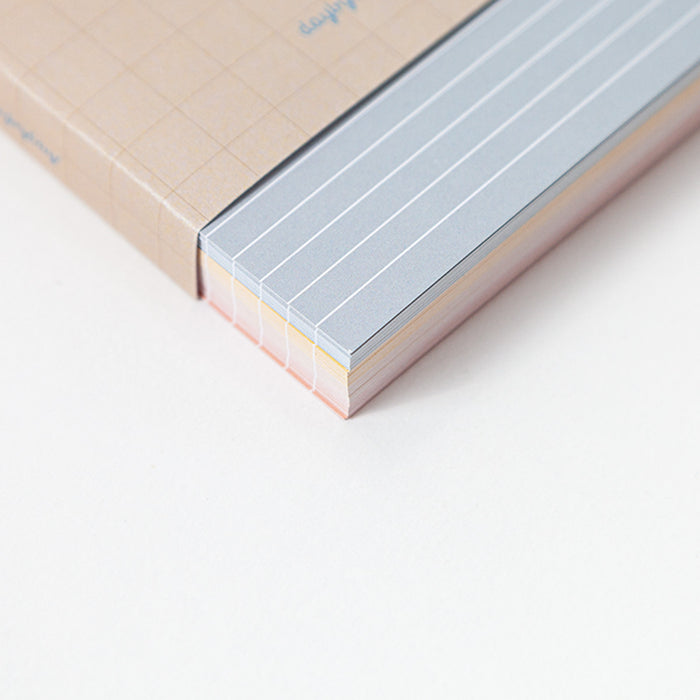 Close-up of a memo card with lined pages on a light background