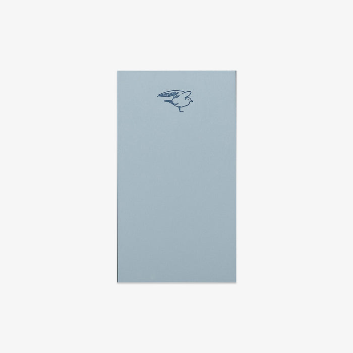 Light blue notepad with a bird illustration on a white background