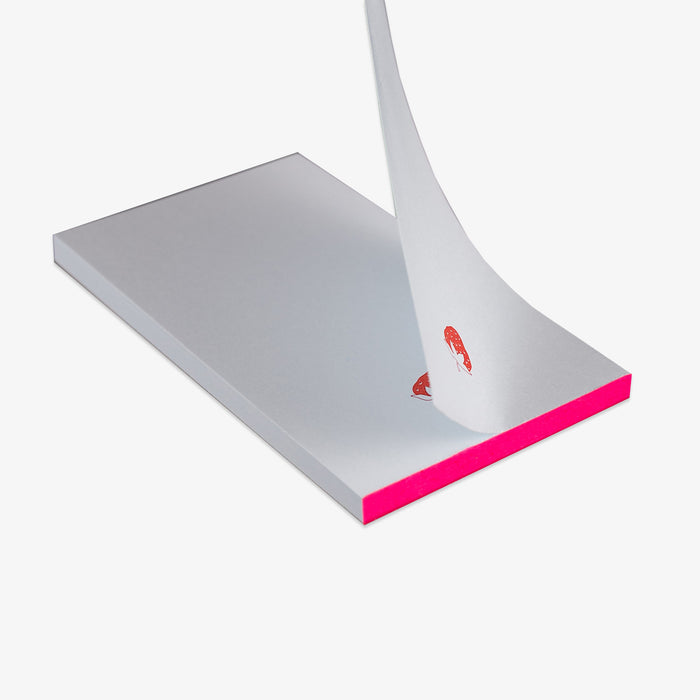 light blue notepad with a pink strawberry on a white background