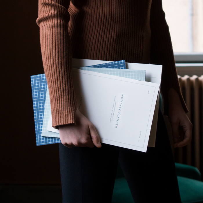 Monthly Planner notebook displayed with other notebooks.