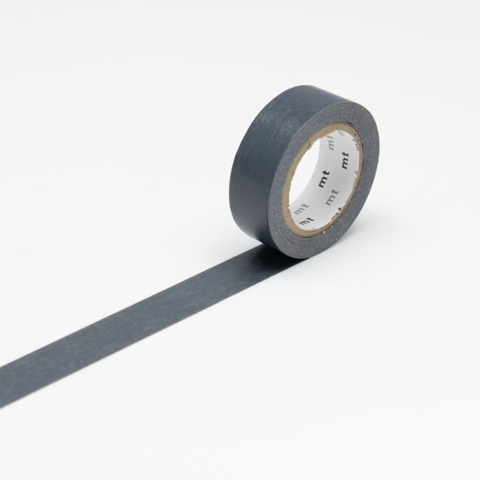 A roll of dark navy masking tape unrolled against a white background.
