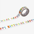 Roll of decorative tape with 'Happy Birthday' text in colorful letters on a white background