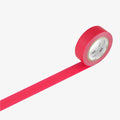 A roll of red MT masking tape unrolled against a white background.