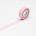 A roll of rose pink masking tape unrolled on a white background