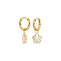 Gold stainless steel hoop earrings with white flower drop charms, hypoallergenic and tarnish-resistant, safe for sensitive skin. Lightweight everyday earrings, water-friendly and durable.