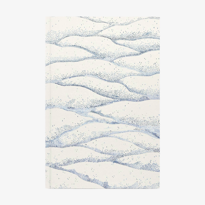 Softcover notebook with wavy blue pattern on a white background