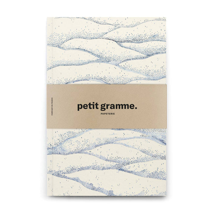 Notebook with wavy pattern and 'petit gramme' branding on a white background