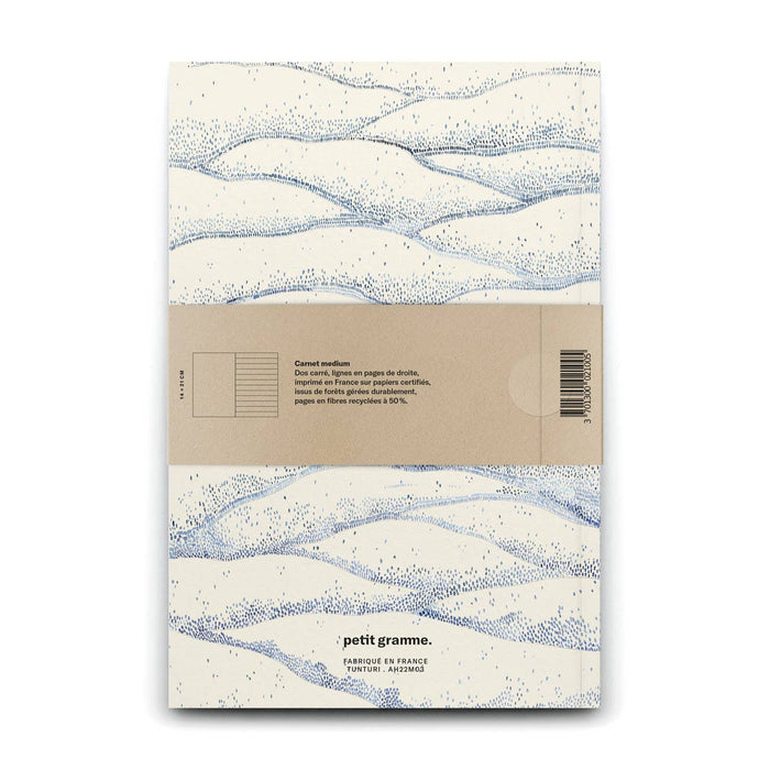 Notebook with wave pattern and Petit Gramme branding on a white background