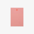 Pink notebook with a paw print design on a white background
