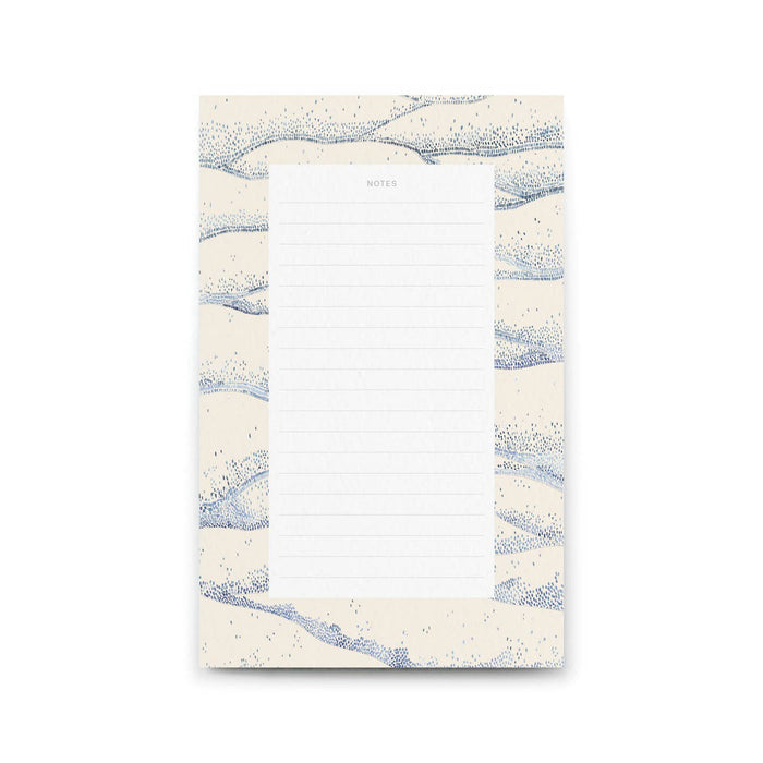 Notepad with blue and white abstract design on a white background