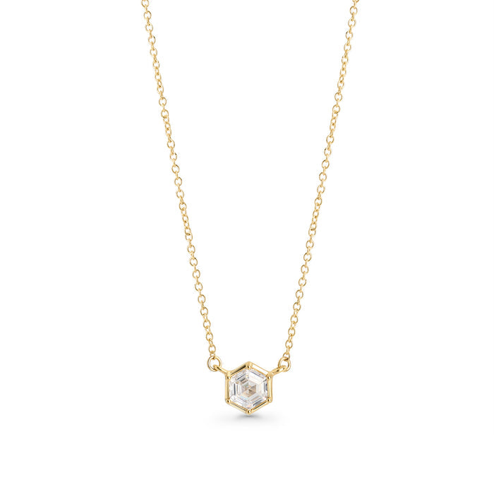 Gold stainless steel necklace with hexagon-cut cubic zirconia pendant, minimalist geometric jewelry design with brilliant stone on delicate chain.