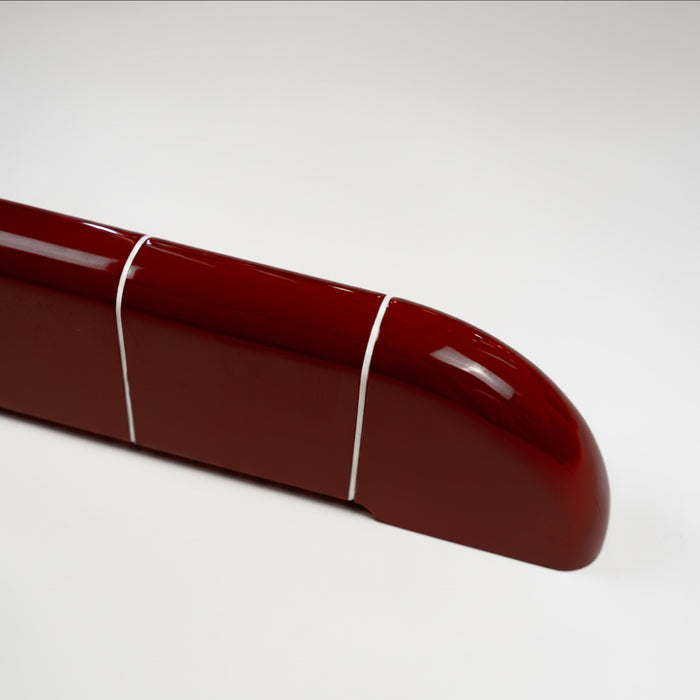 Close-up of the rounded end of the Orbi shelf in glossy Deep Burgundy, highlighting the ceramic-inspired finish.