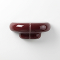 Orbi XS floating shelf in glossy Deep Burgundy, compact handcrafted wall shelf for modern interiors.