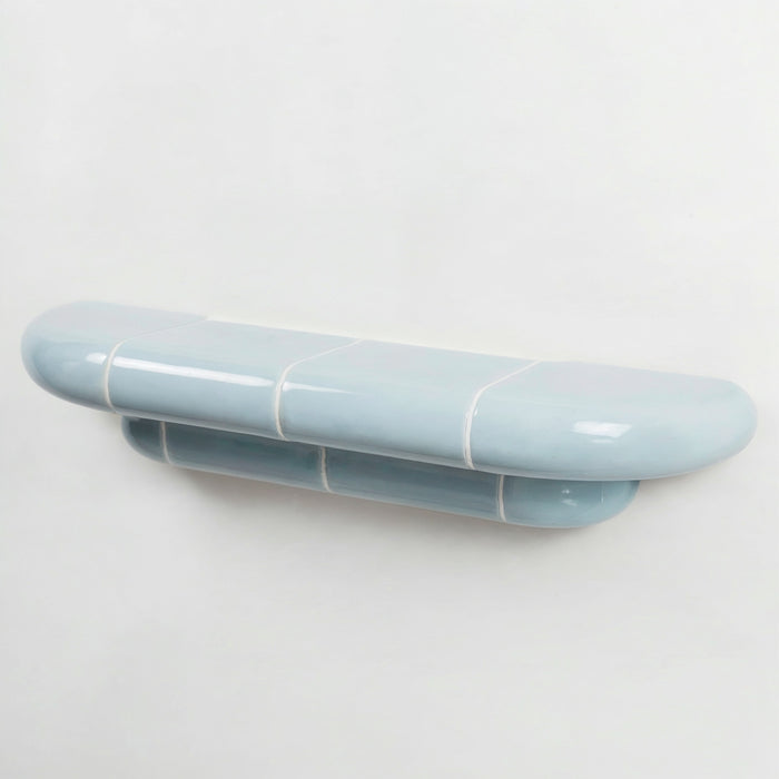 Orbi floating wall shelf in glossy Ice Blue finish, handcrafted in Spain.