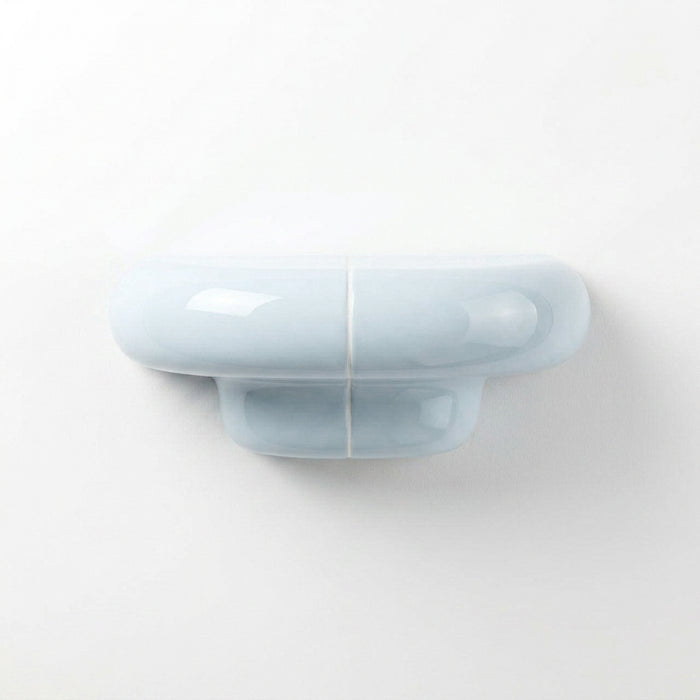 Orbi XS designer shelf in glossy Ice Blue, compact floating shelf for modern spaces.