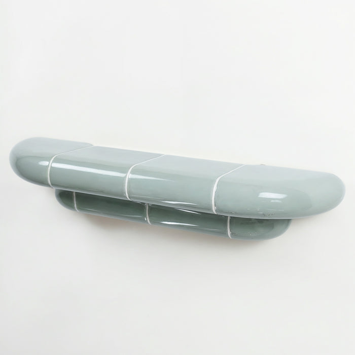 Orbi designer floating shelf in glossy Pastel Mint finish, handcrafted in Spain.