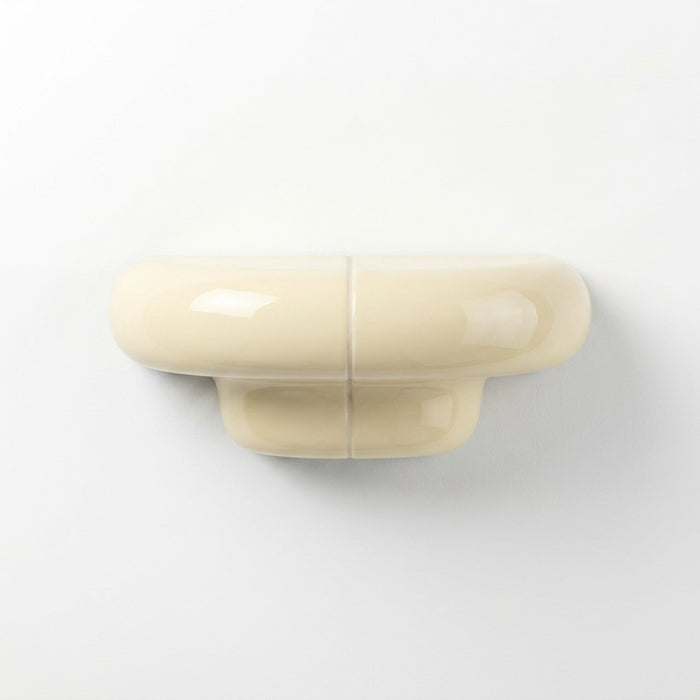 Orbi XS floating wall shelf in glossy Soft Butter, modern handcrafted shelf for contemporary interiors.