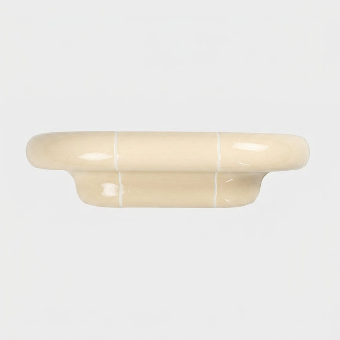 Orbi S modular wall shelf in glossy Soft Butter with a sculptural ceramic-inspired design.