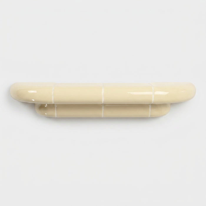 Orbi M floating shelf in glossy Soft Butter, handcrafted designer shelf with rounded forms.
