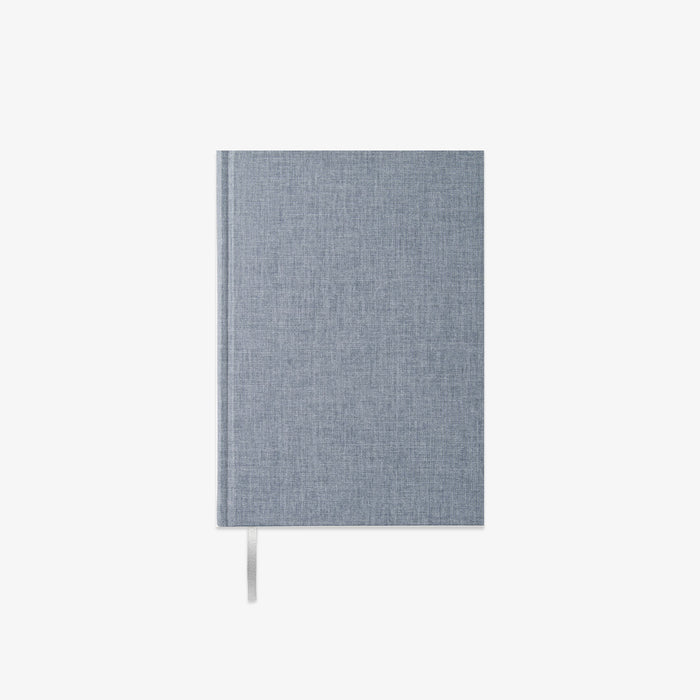 Blue fabric-bound notebook on a white background